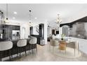 Open kitchen and dinette area with granite countertops and stainless steel appliances at 3201 Dallas Blvd, Orlando, FL 32833