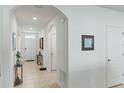 Bright foyer with tile floors, an arched entry, and white walls, offering a welcoming entrance at 3817 Heartleaf Ln, Mount Dora, FL 32757