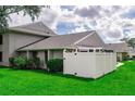 A beautifully maintained property featuring a white fence, fresh greenery, and a well-manicured lawn, creating a welcoming outdoor space at 4438 Pinebark Ave # 4, Orlando, FL 32811