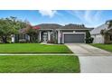 Beautiful home with well-kept lawn, mature trees, and an attached two-car garage at 4825 Waterwitch Point Dr, Orlando, FL 32806
