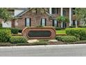 Waterwitch Cove neighborhood sign with brick base and lush landscaping at 4825 Waterwitch Point Dr, Orlando, FL 32806