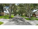 Shaded street with mature trees lining the road, offering a peaceful neighborhood setting at 4825 Waterwitch Point Dr, Orlando, FL 32806