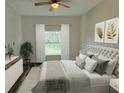 Comfortable bedroom offering a plush bed, ceiling fan, and windows providing natural light at 534 S Adelle Ave, Deland, FL 32720