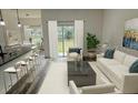Inviting living room featuring hardwood floors, ample natural light, and a modern open floor plan at 534 S Adelle Ave, Deland, FL 32720