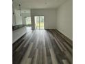 Spacious living area boasting hardwood floors and sliding door access to the backyard at 534 S Adelle Ave, Deland, FL 32720