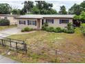 Wide shot of the home's exterior with blue shutters, showcasing the landscaping and fence at 5615 Arundel Dr, Orlando, FL 32808
