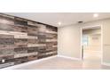 Stylish living room featuring an accent wooden wall, recessed lighting, and bright interior at 5615 Arundel Dr, Orlando, FL 32808