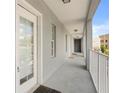 Exterior balcony with white railings, neutral paint, and a textured rug offers a clean outdoor space at 660 Celebration Ave # 250, Kissimmee, FL 34747