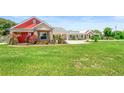 This single-Gathering home has decorative flower beds surrounding the property at 700 Old Geneva Rd, Geneva, FL 32732