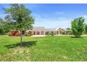 Expansive front lawn with mature trees accenting this unique home at 700 Old Geneva Rd, Geneva, FL 32732