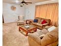 Inviting living room featuring plush carpeting, comfortable seating, and a decorative ceiling fan at 8547 Cedar Cove Dr, Orlando, FL 32819