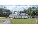 Charming single-story home with a well-maintained lawn and convenient circular driveway at 10750 Sw 110Th St, Dunnellon, FL 34432