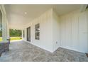Inviting front porch with stone columns and tiled floor at 10750 Sw 110Th St, Dunnellon, FL 34432