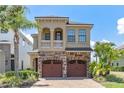Elegant two-story home with stone accents, arched entry, and a well-manicured lawn at 1164 Castle Pines Ct, Reunion, FL 34747