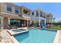 Beautiful backyard pool and spa with outdoor dining and lounge area, perfect for entertaining at 1164 Castle Pines Ct, Reunion, FL 34747