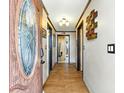 Entryway with stained-glass door, wood-look tile floors, and decorative wall art at 130 Masterpiece Rd, Lake Wales, FL 33898