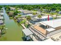 Aerial view of the property showcasing its waterfront location, boat dock, and outdoor entertaining area at 139 Douglas St, Edgewater, FL 32141