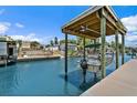 View of canal with boat lift and adjacent waterfront residences at 139 Douglas St, Edgewater, FL 32141