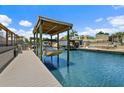 A covered boat lift and dock sit on a canal with waterfront residences at 139 Douglas St, Edgewater, FL 32141