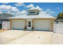 A modern home with a metal roof, two-car garage, and neatly maintained front yard exhibits great curb appeal at 139 Douglas St, Edgewater, FL 32141