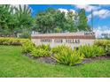 The community sign for Country Club Villas sits amongst the verdant landscaping at 1609 Glen Eagles Way, Orlando, FL 32804