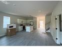 Open concept kitchen with island, stainless appliances and view into dining and living area at 230 Lucile Way, Orlando, FL 32835