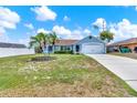 Charming single-story home featuring a well-manicured lawn and lush landscaping at 2375 Belen Dr, Deltona, FL 32738
