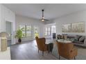 Bright living room featuring modern furnishings, ample natural light, neutral paint, and wood-look floors at 2444 Omaha Dr, Deltona, FL 32738