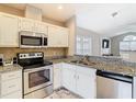 Well-equipped kitchen featuring white cabinets, granite countertops, and stainless steel appliances at 2641 Delcrest Dr, Orlando, FL 32817