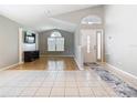 Bright living room featuring tile and wood floors, tall ceilings and plenty of natural light at 2641 Delcrest Dr, Orlando, FL 32817