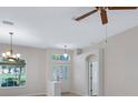 Bright foyer featuring wood-look floors, chandelier, glass paneled front door, and arched doorway at 26908 Honeymoon Ave, Leesburg, FL 34748