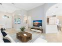 Bright living room featuring neutral walls, tile flooring, modern furniture, and elegant archways at 315 Belhaven Falls Dr, Ocoee, FL 34761
