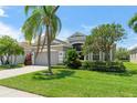 Beautiful home with a landscaped yard and mature trees at 3419 Fernwood Dr, Kissimmee, FL 34741
