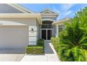 Charming front entrance with a walkway, manicured bushes, and a gray exterior at 3419 Fernwood Dr, Kissimmee, FL 34741