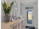 Inviting entryway features stylish decor, a wooden console table, and a round mirror at 3711 Bluethread Way, Poinciana, FL 34759