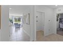 Bright hallway with tile floors, decorative artwork and provides access to living areas at 3711 Bluethread Way, Poinciana, FL 34759