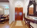 Elegant entryway showcasing a grand double door, decorative tile flooring, and a glimpse into a formal dining space at 3728 Hunters Isle Dr, Orlando, FL 32837