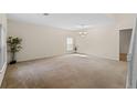 Spacious living room with plush carpeting and ample natural light showcases a comfortable and inviting atmosphere at 404 Bar Ct, Kissimmee, FL 34759