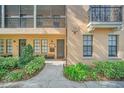 Close up of attractive condo exterior with walkway, porch and manicured landscaping at 506 Mirasol Cir # 202, Celebration, FL 34747