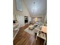 Bright living room featuring high ceilings, modern lighting, and stylish, neutral-toned furniture at 6328 Raleigh St # 814, Orlando, FL 32835