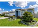 This beautiful home showcases lush landscaping, a well-kept lawn, and a freshly painted facade at 633 Greymount St, Davenport, FL 33837
