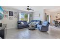 Cozy living room featuring comfortable seating, neutral colors, and a window with natural light at 633 Greymount St, Davenport, FL 33837
