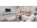 Bright living room featuring an open floor plan, modern decor, and seamlessly integrated staircase at 6331 Breeze Filled Ln, Winter Garden, FL 34787