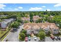 An aerial view showcases the community townhomes with green landscaping, parking, and city views at 645 Stafford Ter # 163, Altamonte Springs, FL 32714