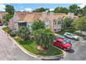 Exterior angle of a townhome with well-kept landscaping, reserved parking, and outdoor patio at 645 Stafford Ter # 163, Altamonte Springs, FL 32714