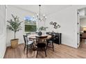 Cozy dining room with wood floors, round table, black chairs, and natural light from the window at 7191 Old Melbourne Hwy, St Cloud, FL 34771