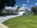 Well-manicured lawn with charming single-story home featuring a spacious two-car garage at 732 Palma Dr, Lady Lake, FL 32159