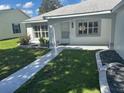 Inviting entrance with well-maintained landscaping and a charming walkway leading to the front door at 732 Palma Dr, Lady Lake, FL 32159