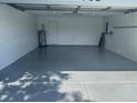 Spacious two-car garage featuring an epoxy floor with ample room for parking and storage at 732 Palma Dr, Lady Lake, FL 32159