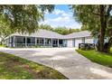 Lovely single-story home with a spacious front yard, covered porch, mature trees, and a long driveway at 9642 Florida Boys Ranch Rd, Clermont, FL 34711